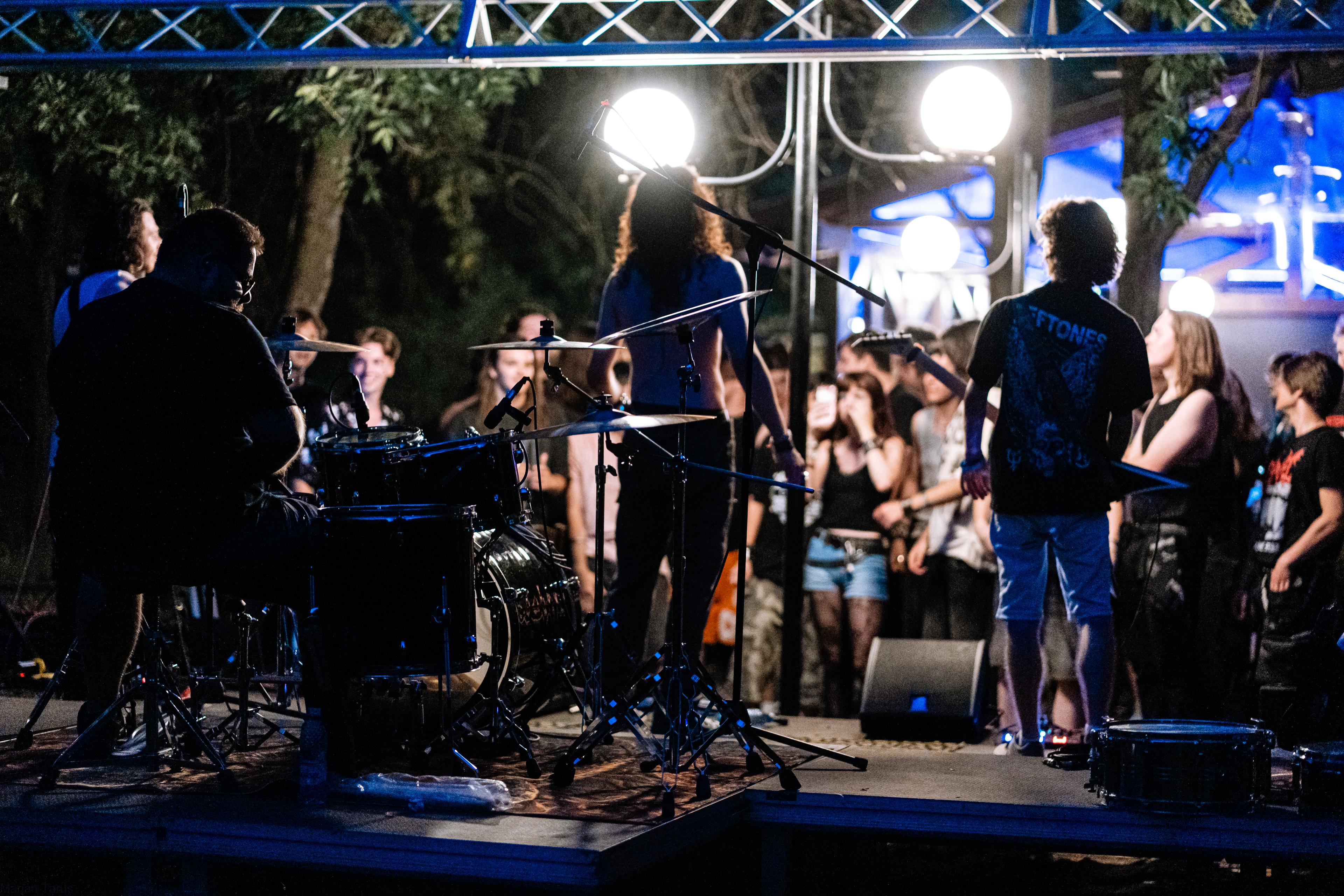 A dark concert stage with purple and blue lights.